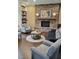 Cozy living room featuring stone fireplace, hardwood floors and neutral decor at 103 Thornwhistle Pl, Garner, NC 27529
