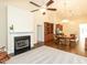 Open concept living area with a fireplace, dining area, and a modern kitchen at 103 Thornwhistle Pl, Garner, NC 27529