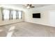 Living room with plush carpeting, ample natural light, and ceiling fan at 103 Thornwhistle Pl, Garner, NC 27529