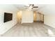 Spacious living room with a large tv screen, plush carpet and a ceiling fan at 103 Thornwhistle Pl, Garner, NC 27529