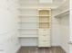Walk-in closet with custom shelving providing ample storage space and organization at 103 Thornwhistle Pl, Garner, NC 27529
