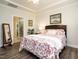 Inviting bedroom with an ensuite bathroom, hardwood floors, and ample natural light at 107 Canary Ct, Raleigh, NC 27610