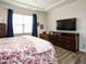 Bright bedroom with hardwood floors, ceiling fan, tray ceilings, and abundant natural light at 107 Canary Ct, Raleigh, NC 27610