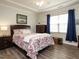 Comfortable bedroom with tray ceiling, ceiling fan, hardwood floors, and ample natural light at 107 Canary Ct, Raleigh, NC 27610