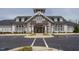 Elegant community clubhouse showcasing stone accents, meticulously landscaped grounds, and convenient parking at 107 Canary Ct, Raleigh, NC 27610