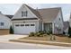Charming home with light blue siding, an attached garage, and a well-manicured lawn at 107 Canary Ct, Raleigh, NC 27610