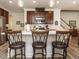 Kitchen with seating, stainless steel appliances, ample counter space and dark wood cabinetry at 107 Canary Ct, Raleigh, NC 27610