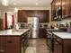 Beautiful kitchen with stainless steel appliances, granite countertops, and dark wood cabinetry at 107 Canary Ct, Raleigh, NC 27610