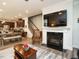 Open living space with a fireplace, television, and a view of the adjacent kitchen and dining area at 107 Canary Ct, Raleigh, NC 27610