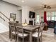 Cozy living room with fireplace, ceiling fan, wood floors, and comfortable seating at 107 Canary Ct, Raleigh, NC 27610