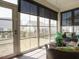 Bright sunroom featuring large windows with privacy shades offering panoramic outdoor views at 107 Canary Ct, Raleigh, NC 27610