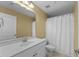 Well-lit bathroom with a large mirror, white vanity, and shower with curtain at 107 Zaharis Cv, Raleigh, NC 27603