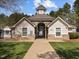 Charming community clubhouse with stone accents, a cupola, and a gated entrance at 107 Zaharis Cv, Raleigh, NC 27603