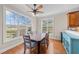 Bright dining room featuring a ceiling fan and large windows offering a scenic outdoor view at 107 Zaharis Cv, Raleigh, NC 27603