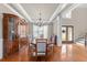 Elegant dining room features coffered ceilings, wood floors, and classic chandelier at 107 Zaharis Cv, Raleigh, NC 27603