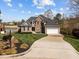 Charming two-story home with manicured lawn, mature landscaping and a long driveway at 107 Zaharis Cv, Raleigh, NC 27603