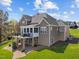 Back of home with a large deck, a patio, and a well-maintained lawn at 107 Zaharis Cv, Raleigh, NC 27603