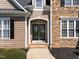 Charming front entrance with stone accents, dark door, and well-manicured landscaping at 107 Zaharis Cv, Raleigh, NC 27603