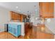Spacious kitchen with granite countertops, wooden cabinetry, and hardwood flooring at 107 Zaharis Cv, Raleigh, NC 27603