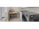 Neat laundry room with modern appliances, storage shelves, and practical workspace at 107 Zaharis Cv, Raleigh, NC 27603