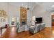 Bright living room with stone fireplace, tall ceilings, and hardwood floors at 107 Zaharis Cv, Raleigh, NC 27603