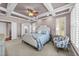 Spacious bedroom with coffered ceilings, neutral carpet and bright shuttered windows at 107 Zaharis Cv, Raleigh, NC 27603
