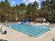 Community pool with multiple lanes for swimming, slide, and covered lounge area at 107 Zaharis Cv, Raleigh, NC 27603