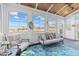 Cozy sunroom with comfortable seating and views of the surrounding landscape at 107 Zaharis Cv, Raleigh, NC 27603