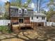 Rear exterior showcasing a private backyard with a deck, brick siding, and white horizontal siding on a two-story home at 1108 Medlin Dr, Cary, NC 27511