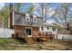 Home's exterior showcasing a deck, a brick facade, and a yard with mature trees at 1108 Medlin Dr, Cary, NC 27511