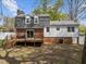 Home's exterior highlighting a deck, a brick facade, and a spacious backyard at 1108 Medlin Dr, Cary, NC 27511