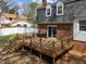Home's exterior featuring a wooden deck, a brick facade, and a white fence in the background at 1108 Medlin Dr, Cary, NC 27511