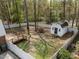 Large fenced backyard featuring a shed, a deck, mature trees providing shade, and a well-maintained lawn at 1108 Medlin Dr, Cary, NC 27511
