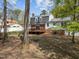 Aerial view of the home's exterior with a deck, brick facade, and large backyard surrounded by trees at 1108 Medlin Dr, Cary, NC 27511