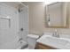 Updated bathroom featuring a white subway tile shower/tub combination and a wood-trimmed mirror over the sink at 1108 Medlin Dr, Cary, NC 27511