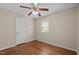 Bedroom showcasing hardwood floors, a ceiling fan, and a white door next to a window at 1108 Medlin Dr, Cary, NC 27511