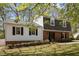Charming two-story home with brick and siding, dormer windows, landscaped front yard, and a walkway to the front door at 1108 Medlin Dr, Cary, NC 27511
