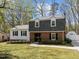 Charming two-story home with brick and siding, dormer windows, landscaped front yard, and a walkway to the front door at 1108 Medlin Dr, Cary, NC 27511