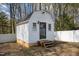 Quaint storage shed featuring vinyl siding, a shingled roof, and charming step entry at 1108 Medlin Dr, Cary, NC 27511