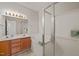 Well-lit primary bathroom includes a dual sink vanity, soaking tub, and separate glass-enclosed shower at 1116 Silky Dogwood Trl, Apex, NC 27502