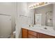 Bright bathroom features double sinks, wooden vanity, and a large mirror with decorative lighting at 1116 Silky Dogwood Trl, Apex, NC 27502