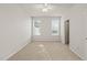 Bright bedroom features neutral carpet, two windows with blinds, and a ceiling fan for comfort at 1116 Silky Dogwood Trl, Apex, NC 27502