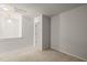 Neutral carpeted bedroom with natural light and an open doorway to another room at 1116 Silky Dogwood Trl, Apex, NC 27502