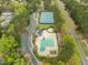 Aerial view of the community pool, tennis courts, and parking area, perfect for active residents at 1116 Silky Dogwood Trl, Apex, NC 27502