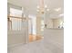 Bright foyer featuring hardwood floors, decorative lighting, and neutral paint colors creating a warm inviting atmosphere at 1116 Silky Dogwood Trl, Apex, NC 27502