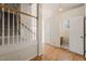 Inviting foyer featuring hardwood floors, staircase, and entry to a bathroom at 1116 Silky Dogwood Trl, Apex, NC 27502