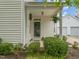 Inviting front porch with decorative plants, creating a welcoming entrance to the home at 1116 Silky Dogwood Trl, Apex, NC 27502