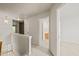 Hallway features neutral carpet, a decorative hanging light, and a view into the bathrooms at 1116 Silky Dogwood Trl, Apex, NC 27502