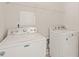 Convenient laundry area with white washer and dryer units for easy laundry care at 1116 Silky Dogwood Trl, Apex, NC 27502