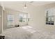 Bright living room features neutral walls, carpet, and natural light from the windows and glass door at 1116 Silky Dogwood Trl, Apex, NC 27502